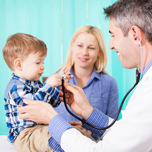 Doctor examining little boy