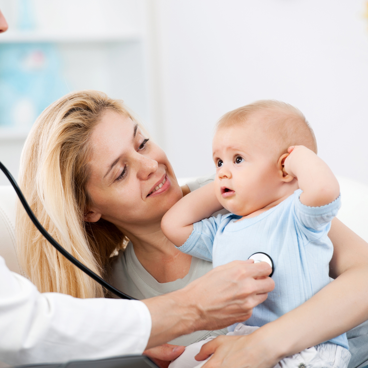 Parent holding infant during physical examination